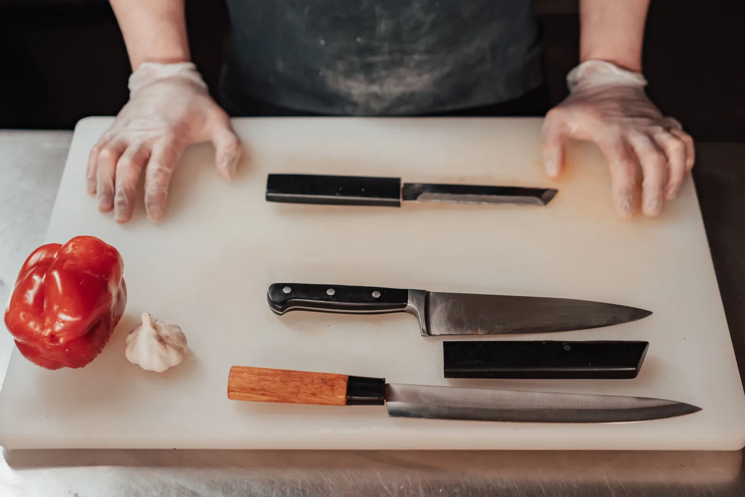 Kitchen knives arranged on a preparation board in a professional kitchen